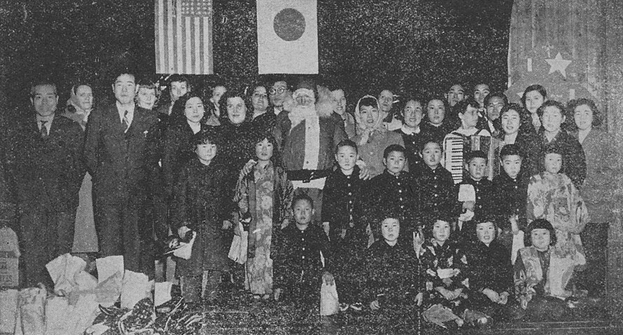 During Christmas 1952, the NCO and Officers' Wives Clubs sponsored a Christmas party for 600 Japanese children from the local community. The clubs raised money for gifts and collected clothes for the children. (U.S. Air Force Photo)