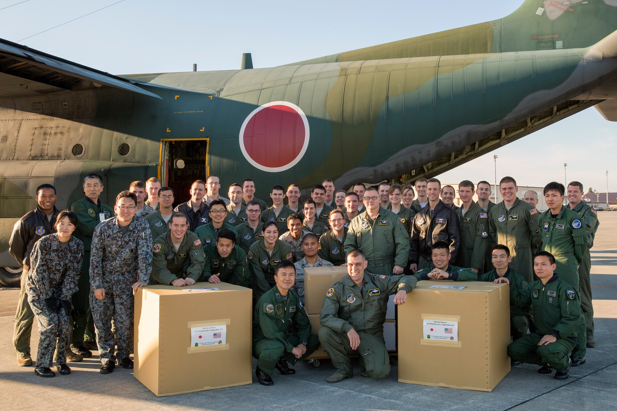 Japan Air Self-Defense Force and U.S. Air Force members gather for a group photo at Yokota Air Base, Japan, Dec. 3, 2014. This is the 2nd year the JASDF members from 401st Squadron, Komaki Air Base delivered Operation Christmas Drop donations. (U.S. Air Force photo by Osakabe Yasuo/Released)  