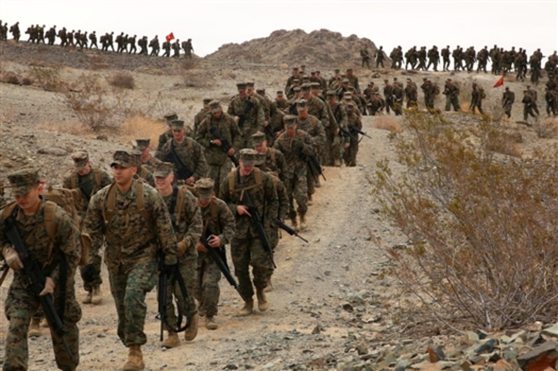 Marines participate in a non-commissioned officer’s hike on the Combat Center at Twentynine Palms, Calif., Dec. 3, 2014. The Marines are from alpha, bravo and charlie companies of headquarters battalion.