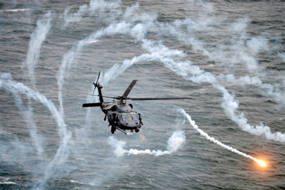 An HH-60 Pavehawk helicopter with the 101st Rescue Squadron, 106th Rescue Wing, tests a defensive system during a simulated rescue of a downed airman near Westhampton Beach, N.Y., Nov. 25 2014. 