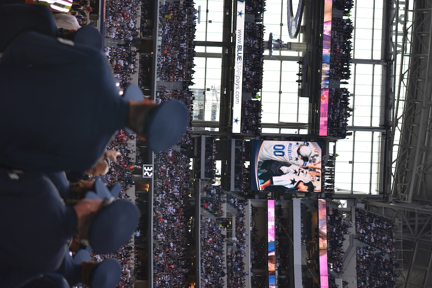 Members of the Air Force Band of the West watch the action from the field tunnel before the Dallas Cowboys' Veterans Appreciation game in Arlington, Texas Nov. 2, 2014.  The band played each branch's march as more than 400 joint service military participants took the field to a standing ovation.  Participants were primarily individuals assigned to various units located on Naval Air Station Joint Reserve Base, Fort Worth, Texas. (U.S. Air Force photo by Mr. Shawn McCowan)