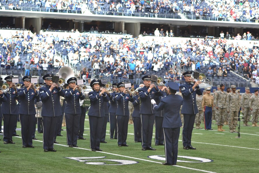 More than 400 servicemembers from all four major branches participate in an on-field joint service halftime event during the Dallas Cowboys' Veterans Appreciation game in Arlington, Texas Nov. 2, 2014.  The Air Force Band of the West played each branch's march as their service's shield was displayed on a large banner.  Participants were primarily individuals assigned to various units located on Naval Air Station Joint Reserve Base, Fort Worth, Texas. (U.S. Air Force photo by Mr. Shawn McCowan)