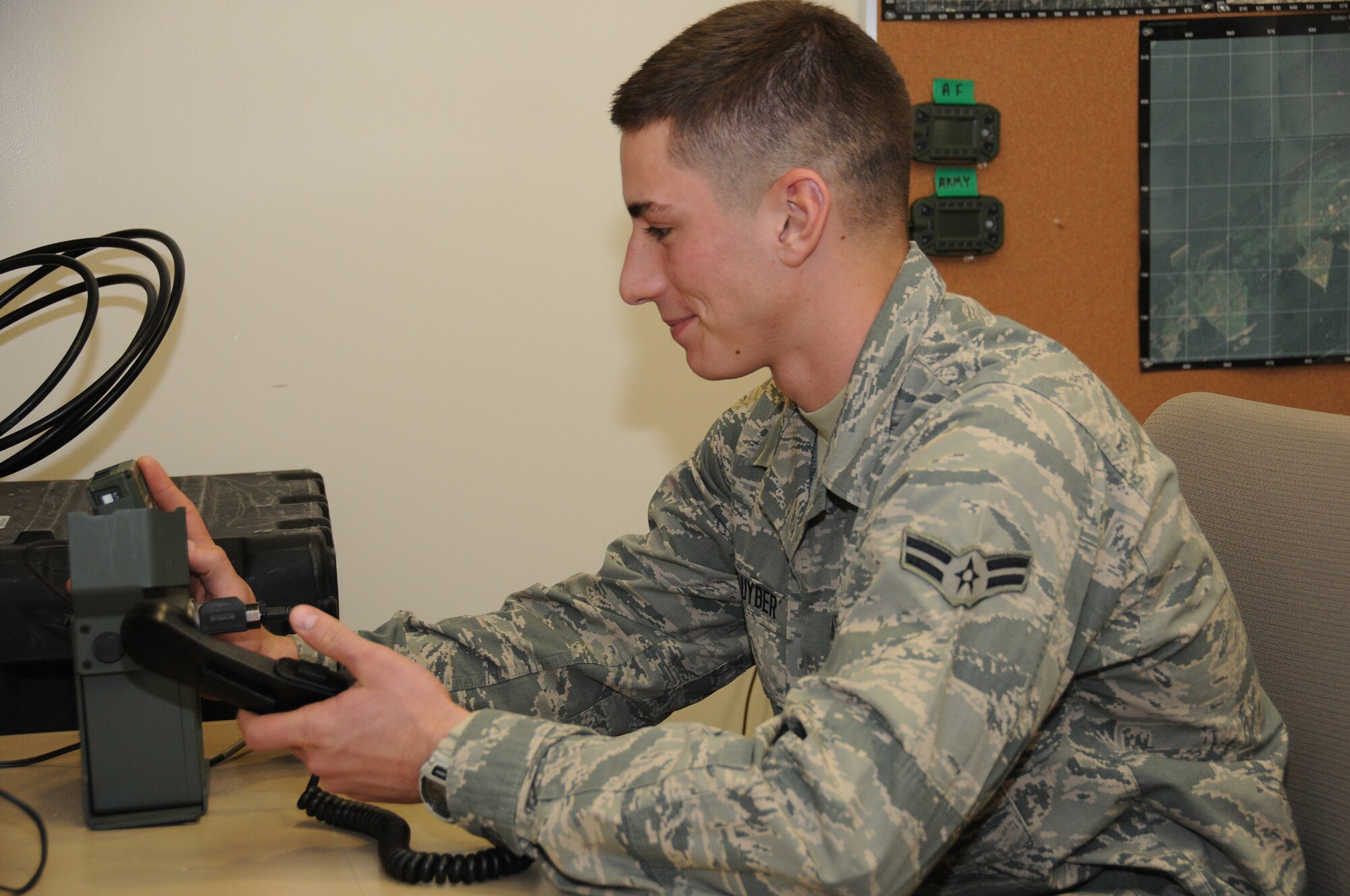 Airman 1st Class Patrick Kluyber, radio frequency transmission systems Airman, 148th Air Support Operations Squadron, dials a channel on the high frequency radio as he did during Exercise Noble Skywave 2014. The exercise was a competition format with points awarded for various criteria, such a completing the greatest number of radio contacts with other participants using various type of antennas, modes and power output. Kluyber teamed up with Tech. Sgt. Nathan Belanger, another radio frequency transmission systems Airman of the 148th, to capture first place in the exercise. (U.S. Air National Guard photo by Staff Sgt. Claire Behney/Released)