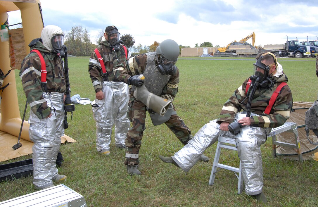 Airmen from the 193rd Special Operations Civil Engineer Squadron remove gear that  is simulated to be contaminated during an exercise Oct. 4 at the Fort Indiantown Gap Regional Training Site in Annville, Pennsylvania. The annual bivouac exercise helps power production and operations personnel, as well as emergency managers and firefighters learn how to master their skills and accomplish their mission under austere field conditions that may include chemical, biological, radiological, nuclear and environmental threats. (U.S. Air National Guard photo by Staff Sgt. Susan Penning/Released)
