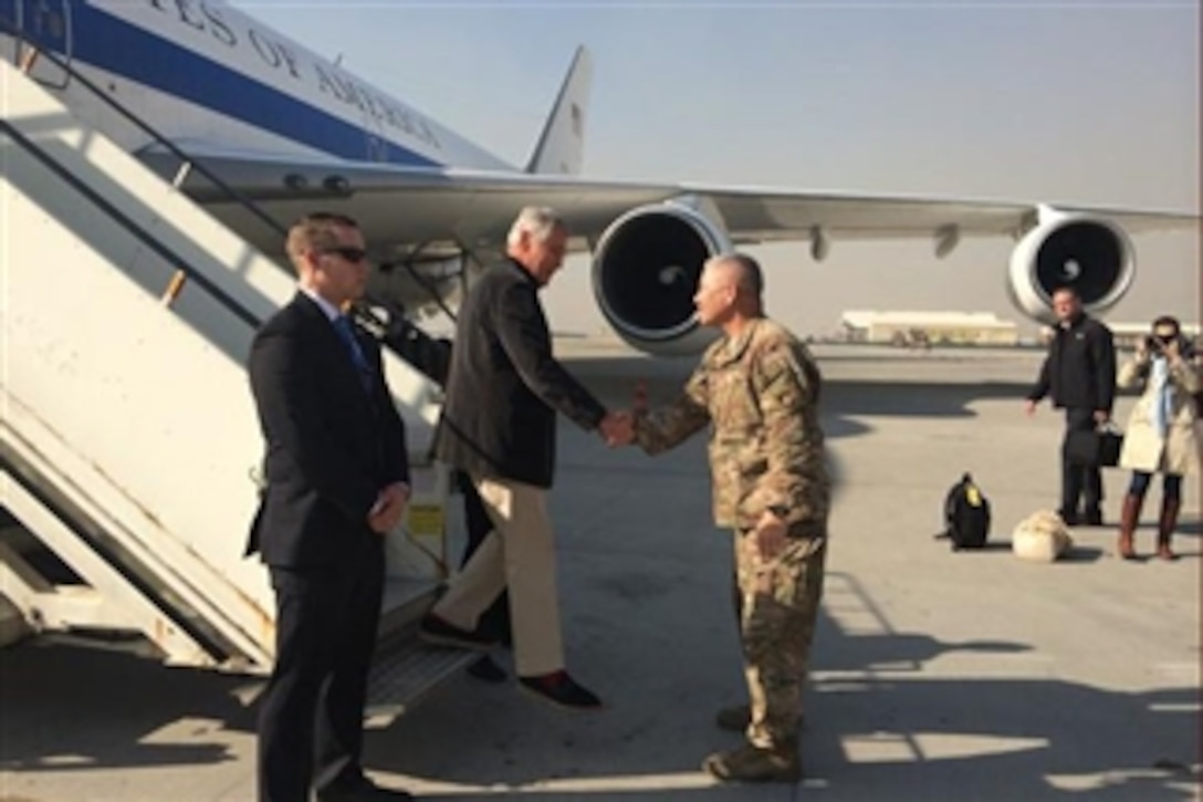 U.S. Defense Secretary Chuck Hagel, center, speaks with U.S. Army Gen. John F. Campbell, right, commander of the International Security Assistance Force and U.S. Forces-Afghanistan, as he arrives in Kabul, Afghanistan, Dec. 6, 2014.