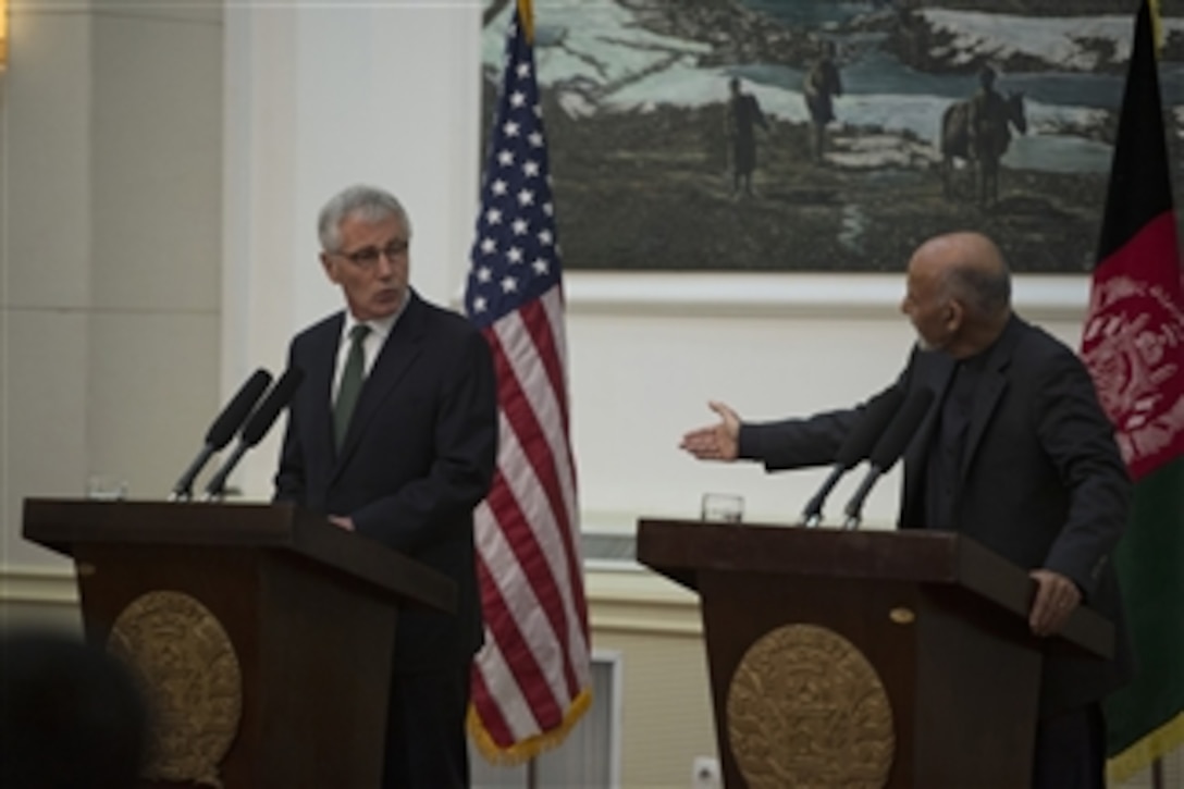 U.S. Defense Secretary Chuck Hagel, left, and Afghan President Ashraf Ghani conduct a joint press conference at the Presidential Palace in Kabul, Afghanistan, Dec. 6, 2014. 