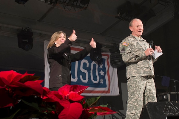 U.S. Army Gen. Martin E. Dempsey, chairman of the Joint Chiefs of Staff, and his wife, Deanie, open a USO show for U.S. service members and their families on Naval Station Rota, Spain, Dec. 6, 2014. Dempsey is visiting U.S. service members who are deployed outside the United States during the holidays.