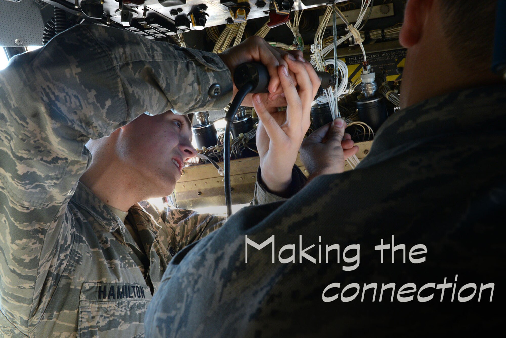 Airman 1st Class Andrew Hamilton, 374th Aircraft Maintenance Squadron instruments and flight controls apprentice, solders together a wire on a fuel quantity indication connector of a C-130 Hercules at Yokota Air Base, Japan, Dec. 2, 2014. Wires are soldered together to create a high quality electrical connection for various systems on the C-130. (U.S. Air Force photo graphic by Senior Airman Desiree Economides/Released)