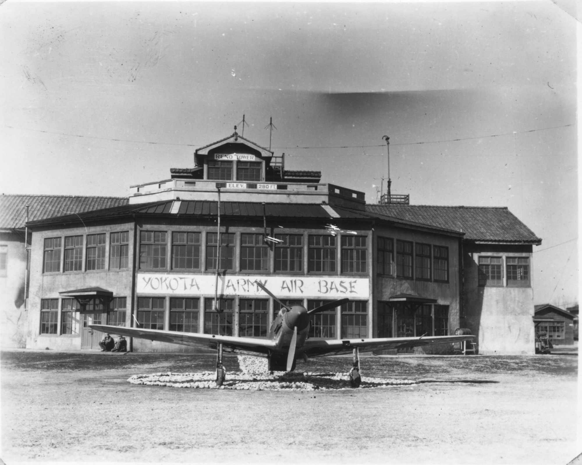 This photo, taken in March of 1946 shows the old operations building, as well as a Japanese fighter that was on static display at Yokota Air Base for many years. (U.S. Air Force photo courtesy of the 374 Airlift Wing History Office)