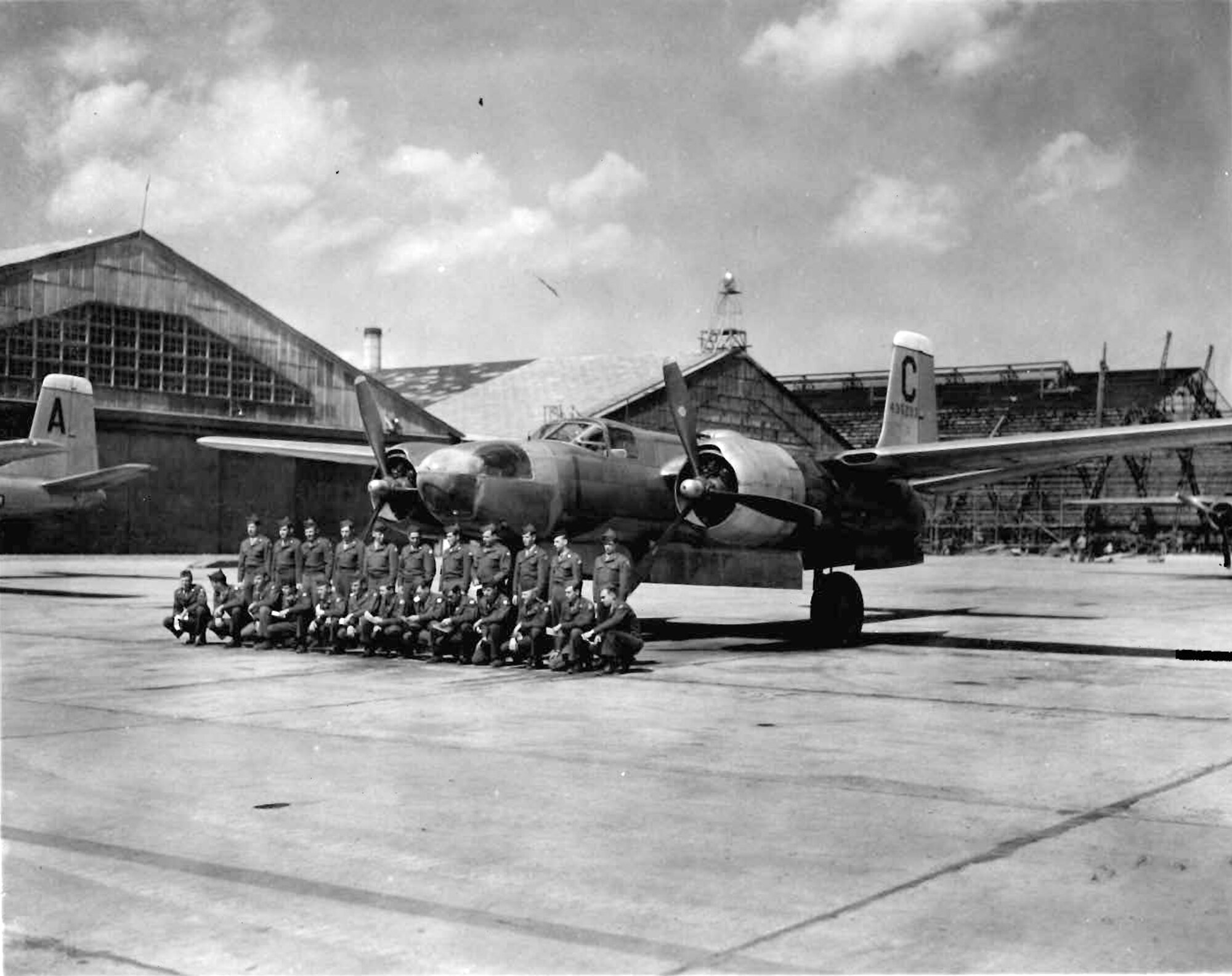 Students from Yokota Air Base's mechanics school pose in front of an A-26 Invader, March 1947. The hangar under construction in the background is still in use today.
(U.S. Air Force photo courtesy of the 374 Airlift Wing History Office)