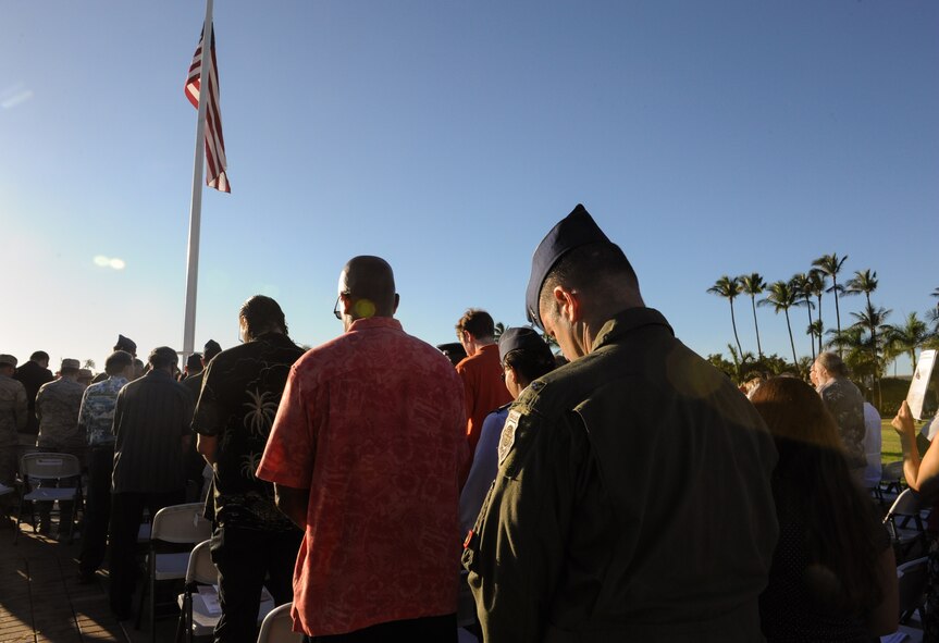Attendees of the Attack on Hickam Field Remembrance Ceremony bow their heads during an invocation at Joint Base Pearl Harbor-Hickam, Hawaii Dec. 7, 2014. This year’s ceremony marks 73 years to the day since the attack occurred. More than 50 survivors and family members of survivors attended the ceremony, which honors the 189 Airmen who lost their lives in the attack. (U.S. Air Force photo by 2nd Lt. Kaitlin Daddona/Released)