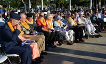 Honorary guests of the Attack on Hickam Field Remembrance Ceremony conclude receiving U.S. flags at Joint Base Pearl Harbor-Hickam, Hawaii Dec. 7, 2014. This year’s ceremony marks 73 years to the day since the attack occurred. More than 50 survivors and family members of survivors attended the ceremony, which honors the 189 Airmen who lost their lives in the attack. (U.S. Air Force photo by Staff Sgt. Alexander Martinez/Released)