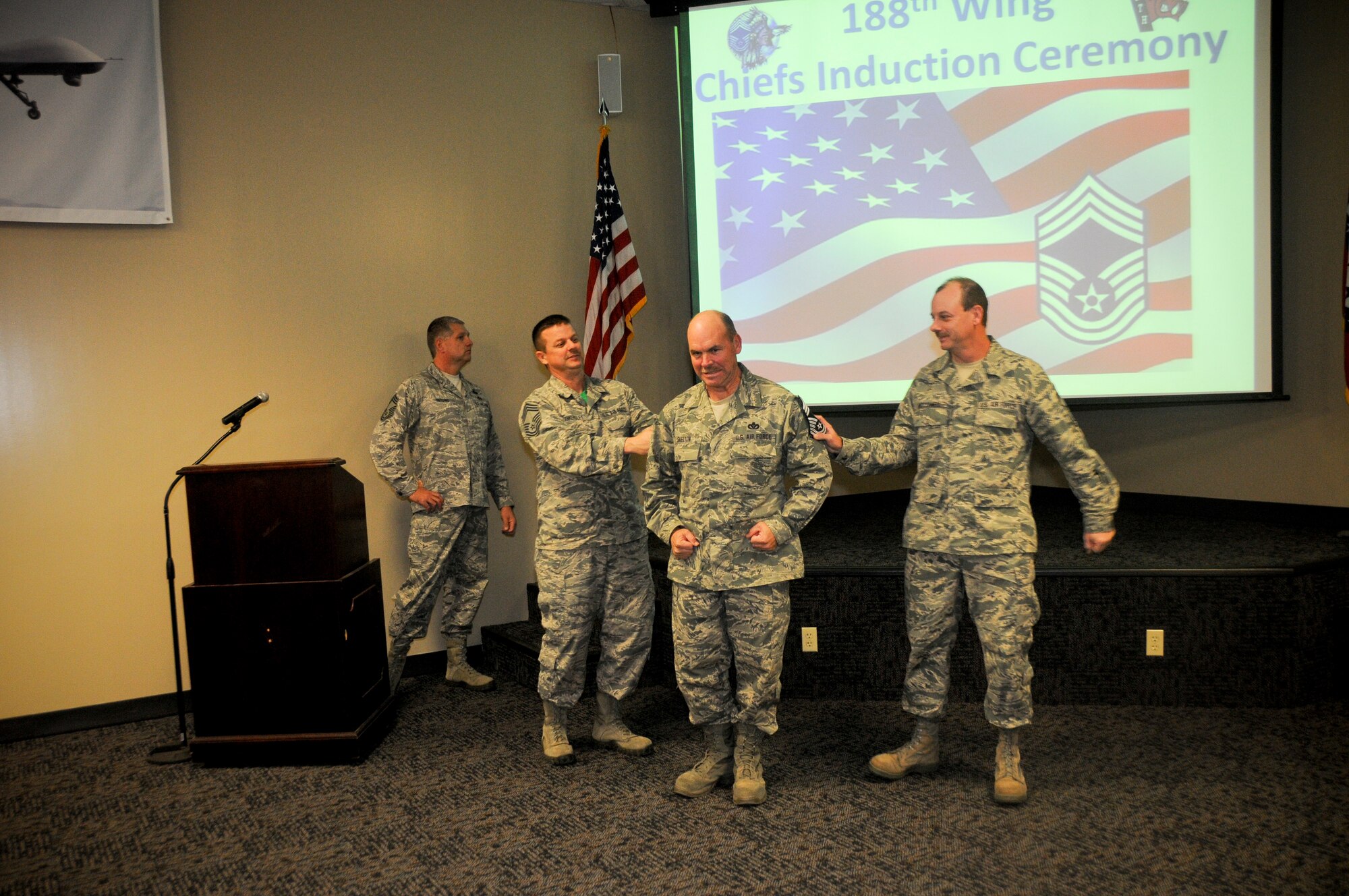 Member of the 188th Wing gather together for the promotion ceremony of Chief Master Sgt. Gary Skelton, Chief of operations for the RED HORSE training center, at Ebbing Air National Guard Base, Fort Smith, Ark., Dec. 7, 2014. Skelton has served 35 years in the Air National Guard and the 188th Wing. (U.S. Air National Guard photo by Airman 1st Class Cody Martin/Released)