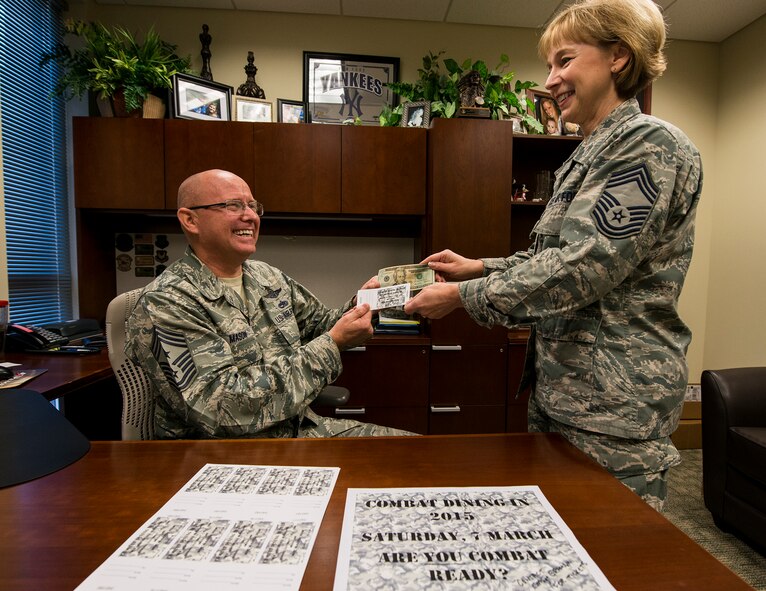 Chief Master Sgt. Tom Mason, the 919th Special Operations Wing command chief, purchases the second combat dining-in ticket from Chief Master Sgt. Karilyn Graham, 919th Force Support Squadron Dec. 7 at Duke Field, Fla.  The wing will host its first “dining-in” in nine years March 7 at 5 p.m. at the field behind the base dining facility.  Tickets are on sale now.  The event includes dinner, games and a guest speaker.  Ticket costs are:  E-1 – E-4 $7, E-5-E-6 $10 and E-7 and above $20.  The event is open to all military personnel assigned to the 919th SOW or the Air Force Special Operations Air Warfare Center working on Duke Field.  Contact any 919th SOW chief master sergeant to purchase tickets.   (U.S. Air Force photo/Tech. Sgt. Cheryl Foster)   