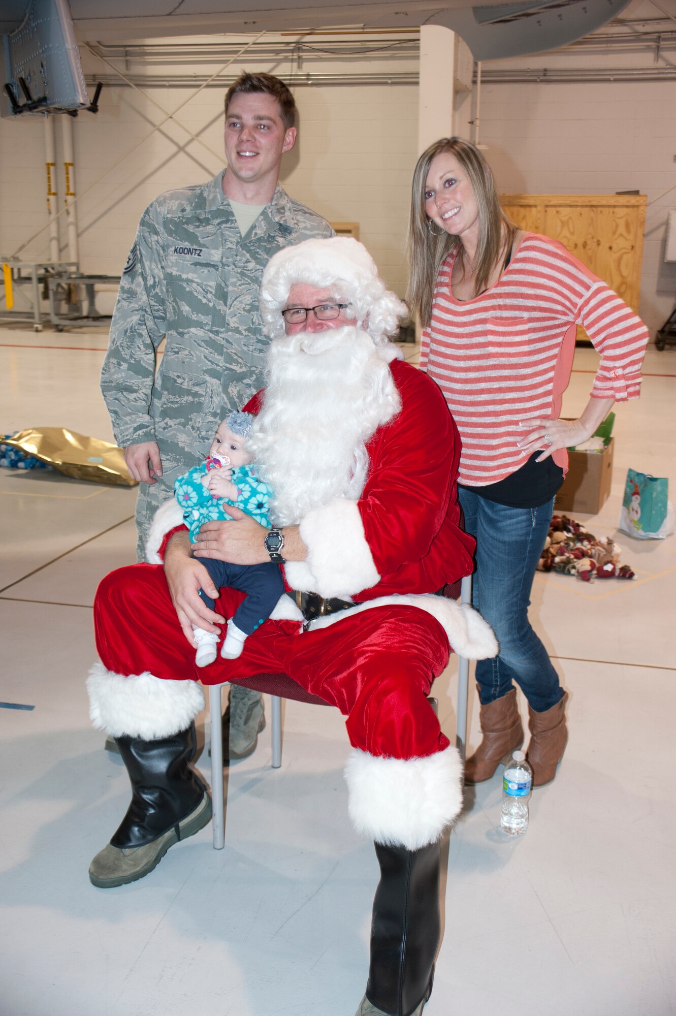 Airmen and families of the 442nd Fighter Wing visit with Santa Claus at the Christmas party Dec. 6. Families got an early Christmas present when troops came home safe and sound from a seven month deployment to Afghanistan. (U.S. Air Force photo by Capt. Denise Haeussler)