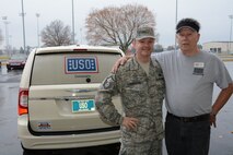 Ray Maddock (right), USO volunteer, and Master Sgt. Bruce Cunningham, 512th Airlift Wing command support section administrator, stand in front of a USO Delaware van during the holiday giveaway Dec. 6, 2014, at Dover Air Force Base, Del. For several hours in the morning, military members and their families stopped by the organization’s warehousing facility on base to pick up free goods ranging from snacks to toiletries that were donated by local and national businesses. (Air Force photo/Senior Airman Joe Yanik)