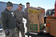 Airmen from the 46th Aerial Port Squadron weigh boxes filled with canned goods and other non-perishable items donated by personnel throughout the 512th Airlift Wing. The donations were part of the inaugural Liberty Wing Food Drive Challenge sponsored by the 512th AW Diversity Partnership and Airmen & Family Readiness. 512th AW organizations competed against each other for the largest amount of food for the challenge. Over 300 pounds of food was donated and will be provided to military families in need. (U.S. Air Force photo/2nd Lt. Steve Lewis)