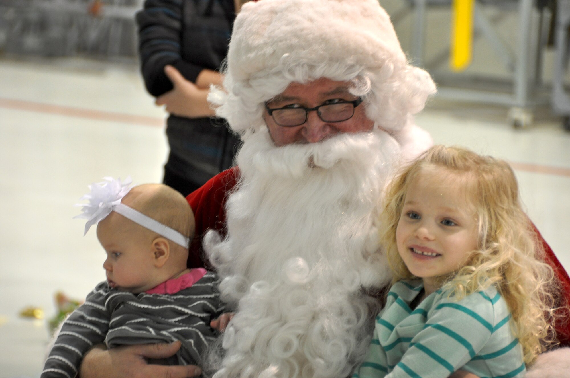 Santa greeted children of members of the 442d Fighter Wing during the Christmas party December 6 at Whiteman AFB, Mo. Members of Missouri’s Civil Air Patrol assisted as elves, handing out gifts that were donated from the local community. (Photo by the Civil Air Patrol)