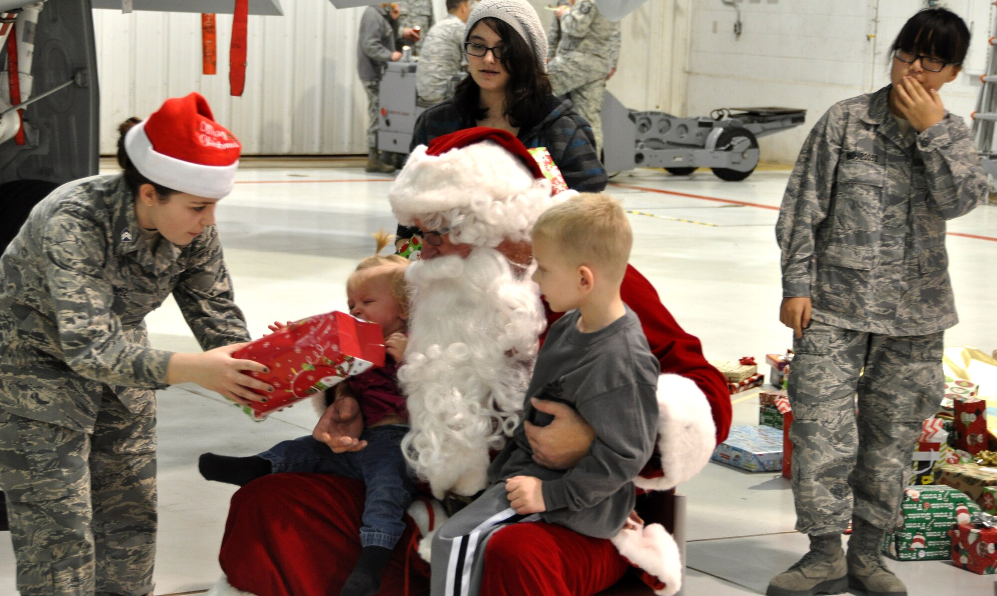 Santa greeted children of members of the 442d Fighter Wing during the Christmas party December 6 at Whiteman AFB, Mo. Members of Missouri’s Civil Air Patrol assisted as elves, handing out gifts that were donated from the local community. (Photo by the Civil Air Patrol)