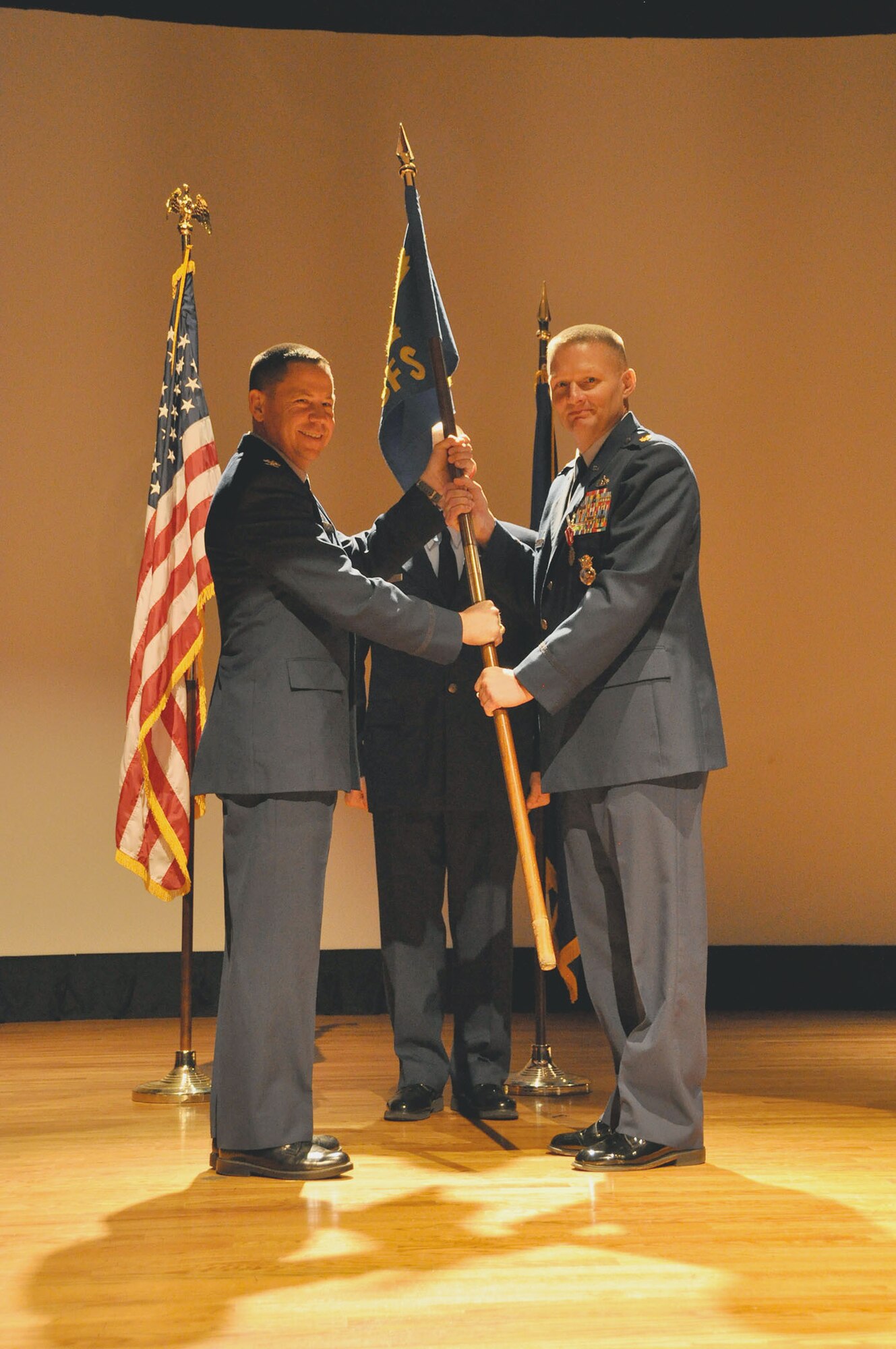 Col. James B. Hurley (left), 315th Mission Support Group commander, and Maj. Shawn M. Swarz (right), outgoing 315th Security Forces Squadron commander, pose with the squadron's guidon as they conduct the change of command ceremony for the 315 SFS. (U.S. Air Force photo by Staff Sgt. Bobby Pilch)