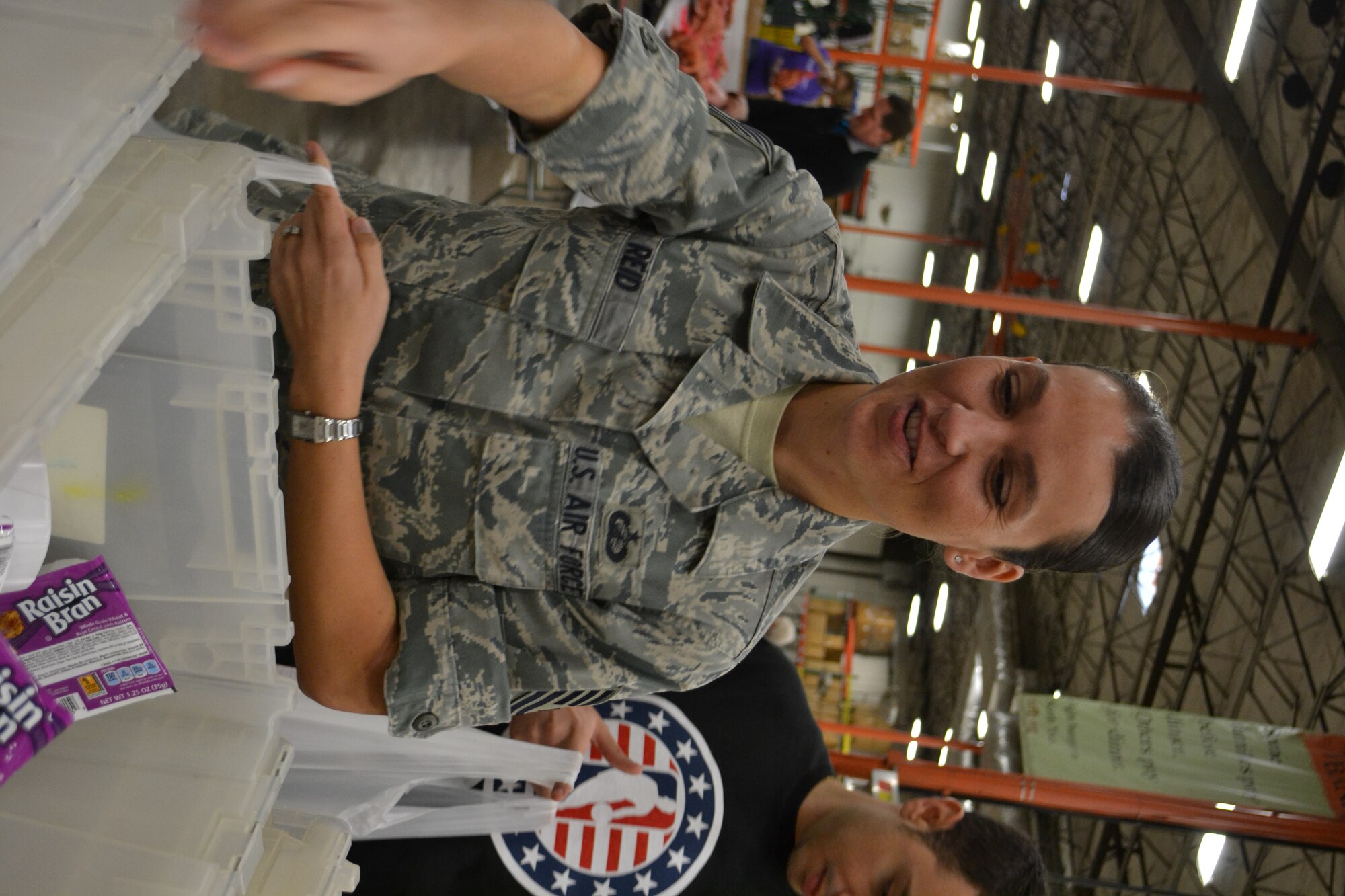 Tech. Sgt. Petra Reid, assigned to 301st Financial Management, fills meal packages with members of 301st Fighter Wing, 10th Air Force, a local Army unit, and Navy personnel from Naval Air Station Fort Worth Joint Reserve Base, Texas, kick off the Commitment to Service program with the Dallas Mavericks at the North Texas Food Bank Nov. 4 in Dallas.  The food bank announced that the effort provided 4,550 meals to underprivileged children in the Dallas and Fort Worth area. (U.S. Air Force photo by Mr. Shawn McCowan)