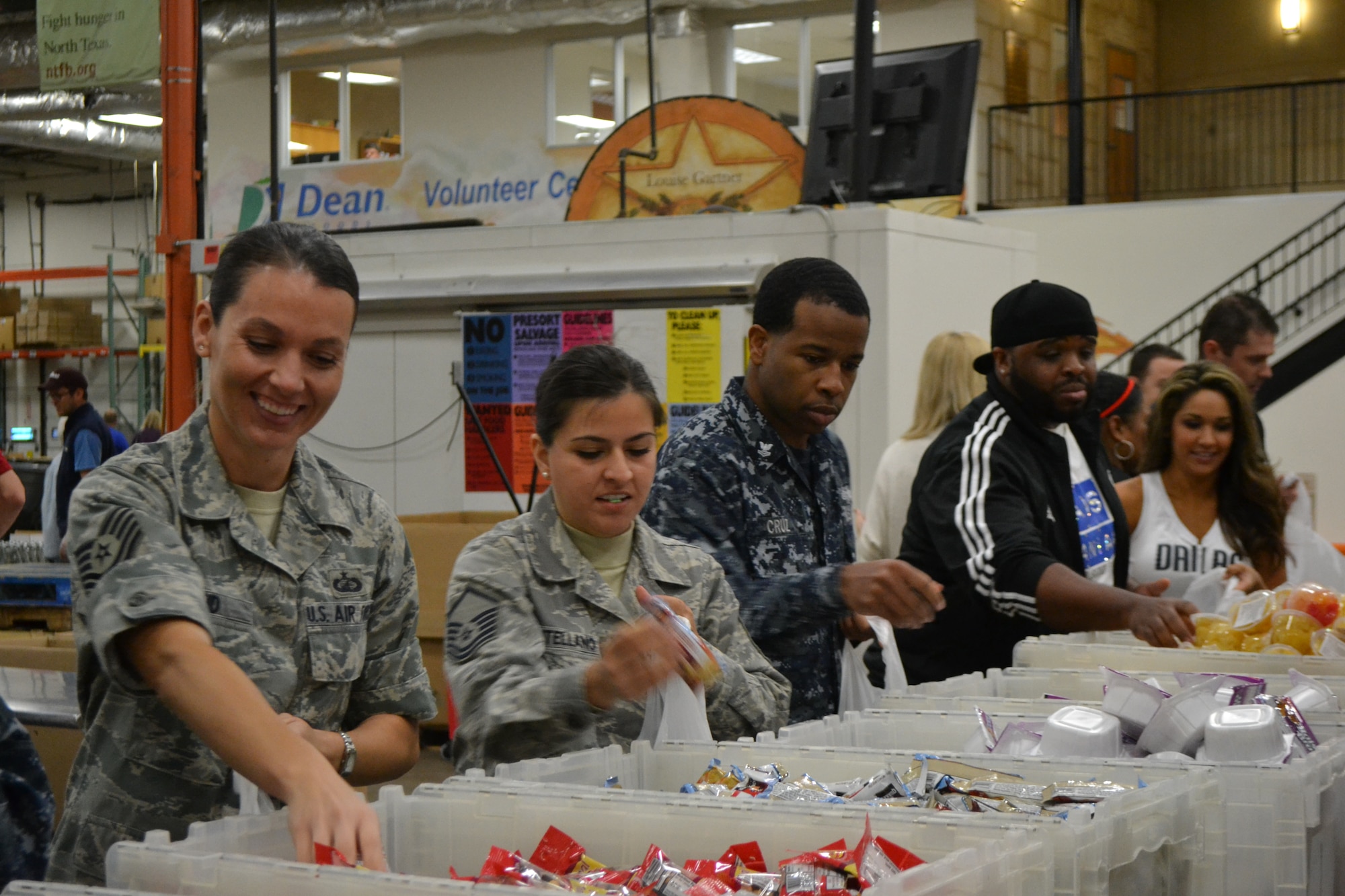 Members of 301st Fighter Wing, 10th Air Force, a local Army unit, and Navy personnel from Naval Air Station Fort Worth Joint Reserve Base, Texas, kick off the Commitment to Service program with the Dallas Mavericks at the North Texas Food Bank Nov. 4 in Dallas.  The food bank announced that the effort provided 4,550 meals to underprivileged children in the Dallas and Fort Worth area. (U.S. Air Force photo by Mr. Shawn McCowan)