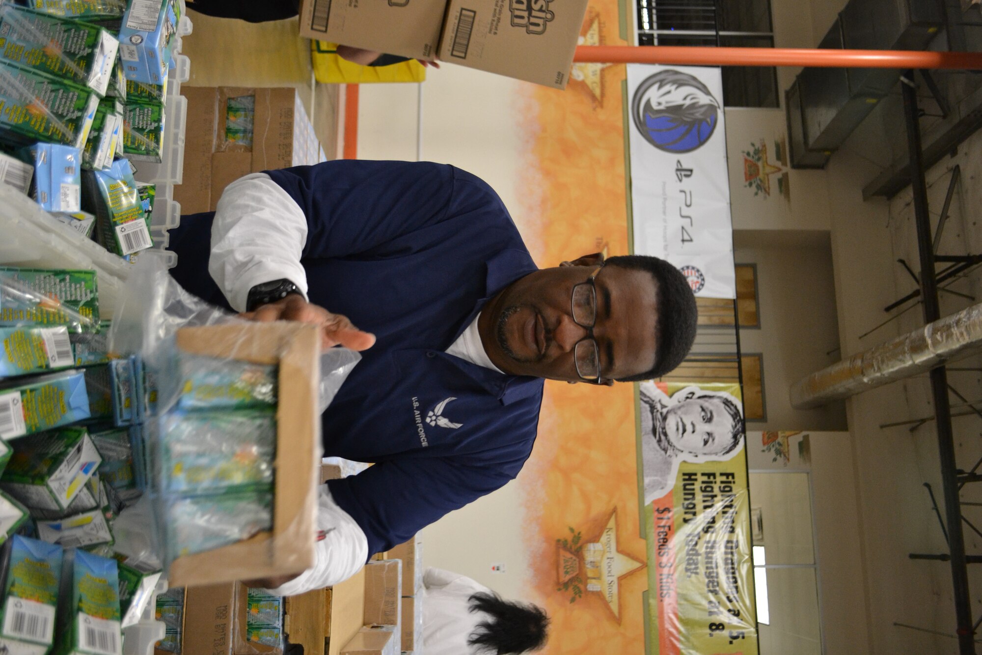 Mr. Darryl Collins, 301st Fighter Wing Protocol Officer, refills meal items with other members of 301st Fighter Wing, 10th Air Force, a local Army unit, and Navy personnel from Naval Air Station Fort Worth Joint Reserve Base, Texas, to kick off the Commitment to Service program with the Dallas Mavericks at the North Texas Food Bank Nov. 4 in Dallas.  The food bank announced that the effort provided 4,550 meals to underprivileged children in the Dallas and Fort Worth area. (U.S. Air Force photo by Mr. Shawn McCowan)