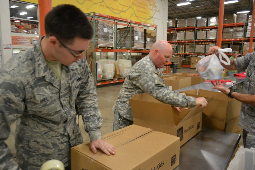 Airman 1st Class Michael Abel, 301st Aircraft Maintenance member, sealed packaged meals with other members of 301st Fighter Wing, 10th Air Force, a local Army unit, and Navy personnel from Naval Air Station Fort Worth Joint Reserve Base, Texas, to kick off the Commitment to Service program with the Dallas Mavericks at the North Texas Food Bank Nov. 4 in Dallas.  The food bank announced that the effort provided 4,550 meals to underprivileged children in the Dallas and Fort Worth area. (U.S. Air Force photo by Mr. Shawn McCowan)