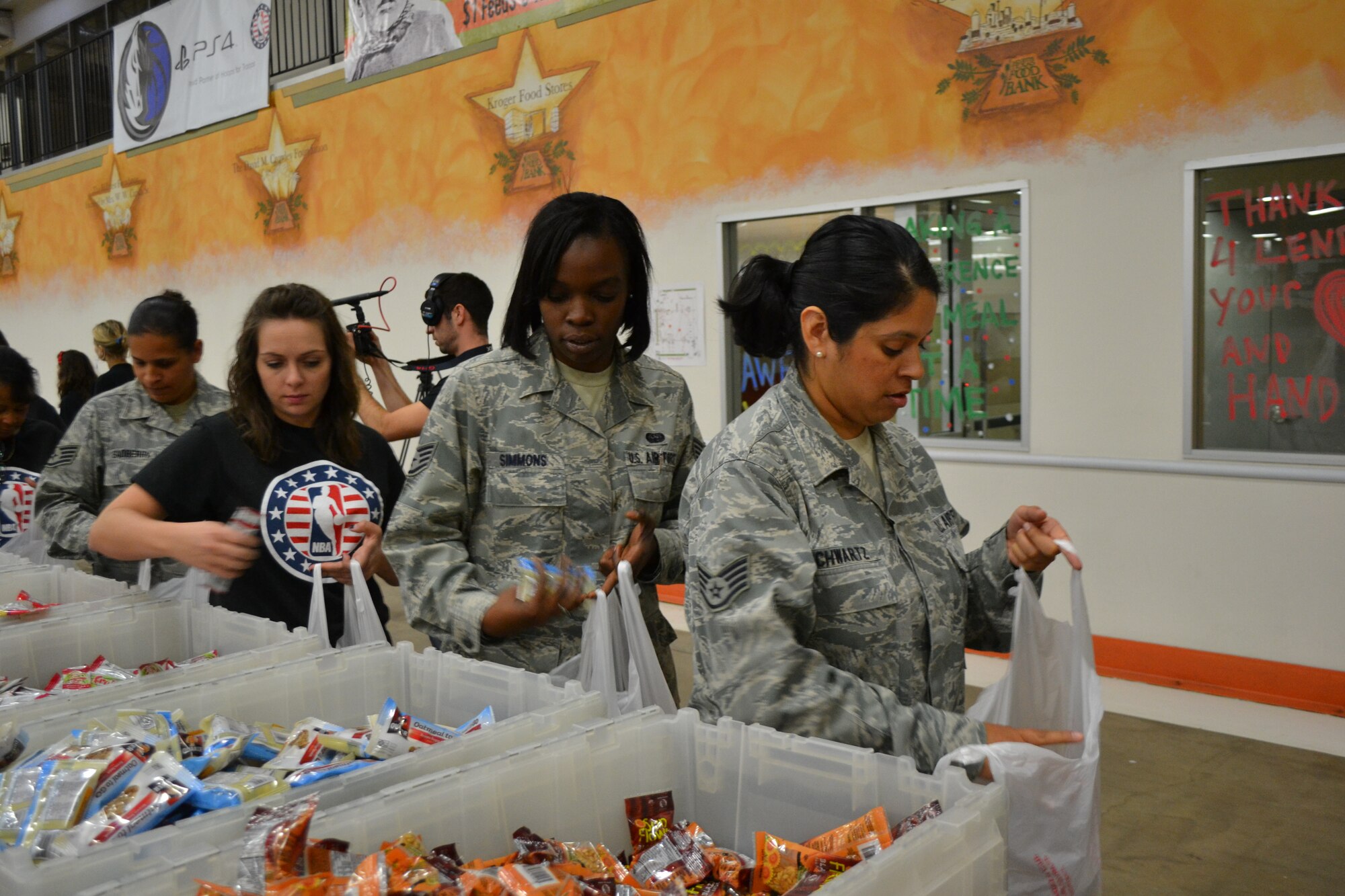 Members of 301st Fighter Wing, 10th Air Force, a local Army unit, and Navy personnel from Naval Air Station Fort Worth Joint Reserve Base, Texas, kicked off the Commitment to Service program with the Dallas Mavericks at the North Texas Food Bank Nov. 4 in Dallas.  The food bank announced that the effort provided 4,550 meals to underprivileged children in the Dallas and Fort Worth area. (U.S. Air Force photo by Mr. Shawn McCowan)