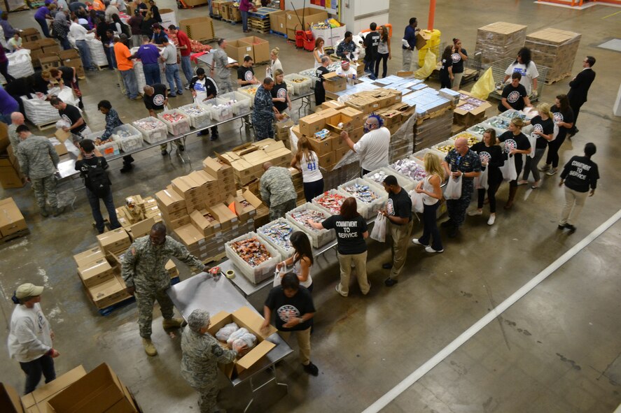 Members of 301st Fighter Wing, 10th Air Force, a local Army unit, and Navy personnel from Naval Air Station Fort Worth Joint Reserve Base, Texas, kicked off the Commitment to Service program with the Dallas Mavericks at the North Texas Food Bank Nov. 4 in Dallas.  The food bank announced that the effort provided 4,550 meals to underprivileged children in the Dallas and Fort Worth area. (U.S. Air Force photo by Mr. Shawn McCowan)