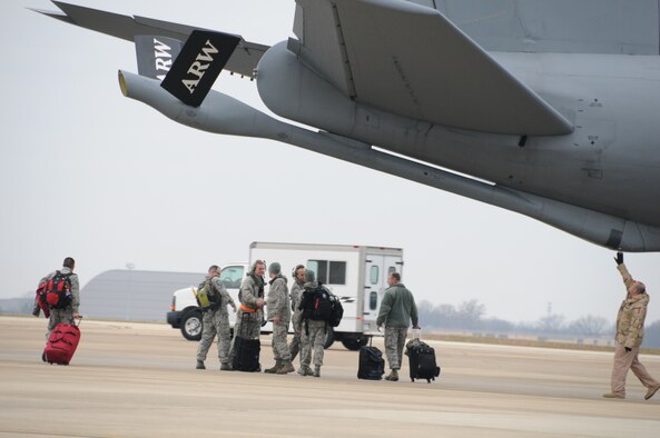 A group of Airmen from the 459th Maintenance Group prepare to board a KC-135 Stratotanker, Joint Base Andrews, Maryland, December 6, 2014. The 459th Maintenance Group  and Operations Group deployed to the 379th Air Expeditionary Wing in an undisclosed location in Southwest Asia and will provide aerial refueling in support of Operation Enduring Freedom. (Staff Sgt. Amber Russell) 

