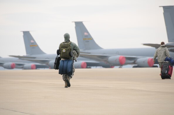 An Airman from the 459th Maintenance Group walks out to a KC-135 Stratotanker, Joint Base Andrews, Maryland, December 6, 2014. The 459th Maintenance Group and Operations Group deployed to the 379th Air Expeditionary Wing in an undisclosed location in Southwest Asia and will provide aerial refueling in support of Operation Enduring Freedom. (Staff Sgt. Amber Russell) 

