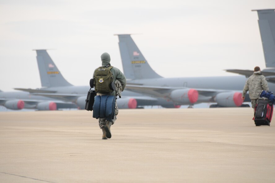 An Airman from the 459th Maintenace Group walks out to a KC-135 Stratotanker, Joint Base Andrews, Maryland, December 6, 2014. 

The 459th Maintenance and Operations Group deployed to the 379th Air Expeditionary Wing in an undisclosed location in Southwest Asia and will provide aerial refueling in support of Operation Enduring Freedom. (Staff Sgt. Amber Russell)
