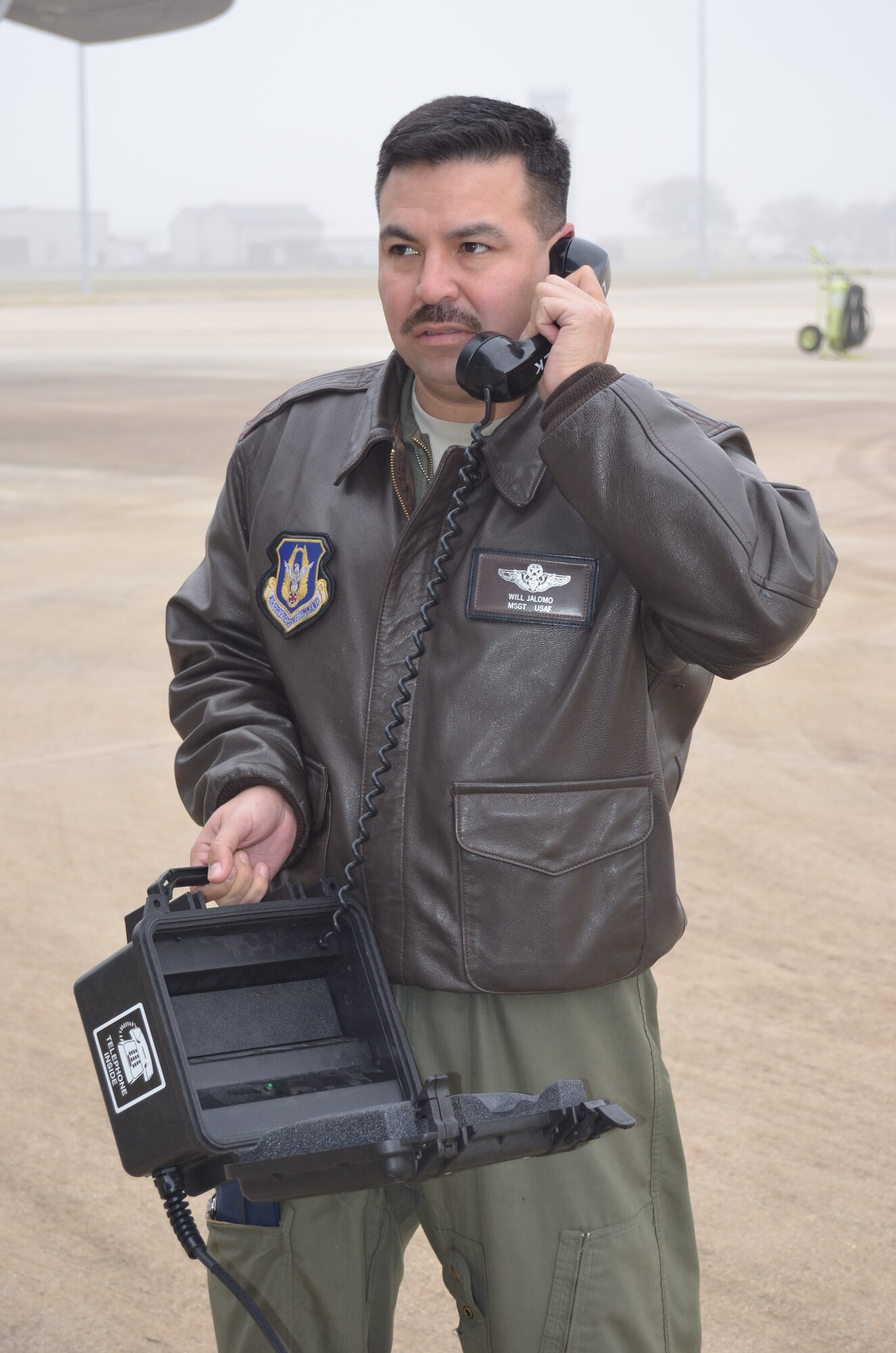Master Sgt. Guillermo, a 68th Airlift Squadron flight engineer, speaks to a negotiator during the anti-hijacking exercise held Dec. 5, 2014 on Joint Base San Antonio-Lackland, Texas. (U.S. Air Force Photo/ Maj. Tim Wade)