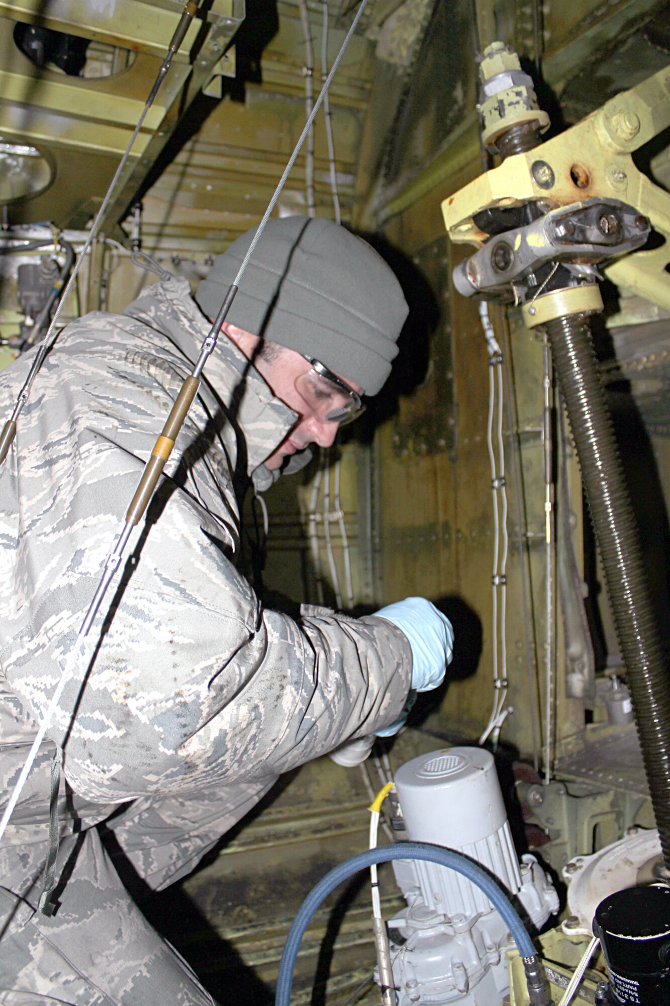 141206-Z-VA676-032 – Working inside the aircraft’s fuselage, Airman 1st Class Mike Fontana, 191st Maintenance Squadron,  prepares to lubricate the metal rod that raises and lowers the boom on a KC-135 Stratotanker at Selfridge Air National Guard Base, Mich., Dec. 6, 2014. Fontana has been working as a crew chief at Selfridge for about a year. (U.S. Air National Guard photo by Tech. Sgt. Dan Heaton)