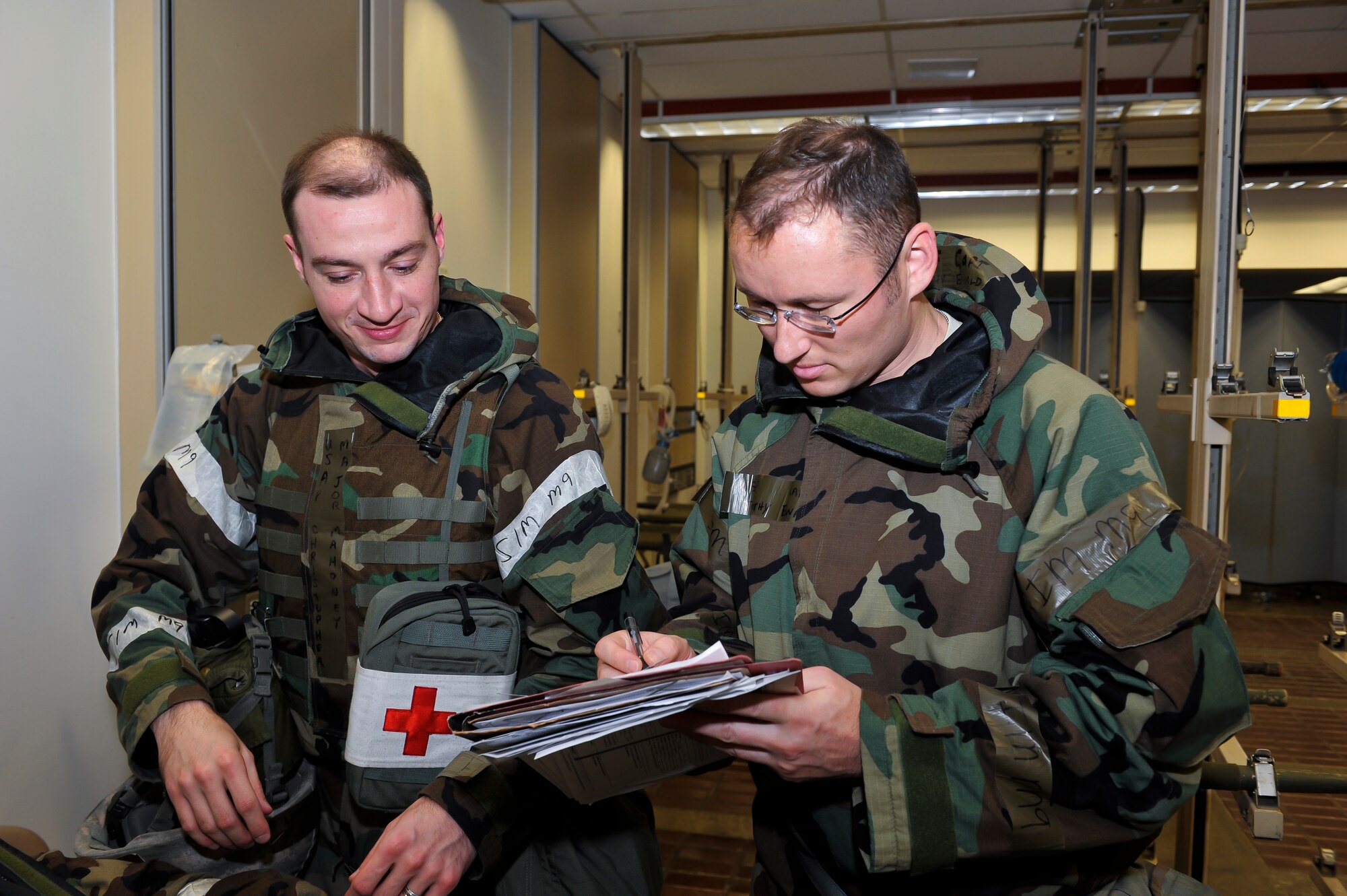 Maj. Christopher Mahoney, 51st Medical Operations Squadron general surgeon, and Capt. Timothy Ewald, 51st MDOS mobile field surgical team orthopedic surgeon, review a chart to check the patients’ vitals, x-rays and lab results after a simulated injury Dec. 6, 2014, at Osan Air Base, Republic of Korea. The exercise focuses on readiness, testing Osan’s wartime procedures, and realistically looking at our ability to defend the base, execute operations and receive follow-on forces. (U.S. Air Force photo by Senior Airman David Owsianka)