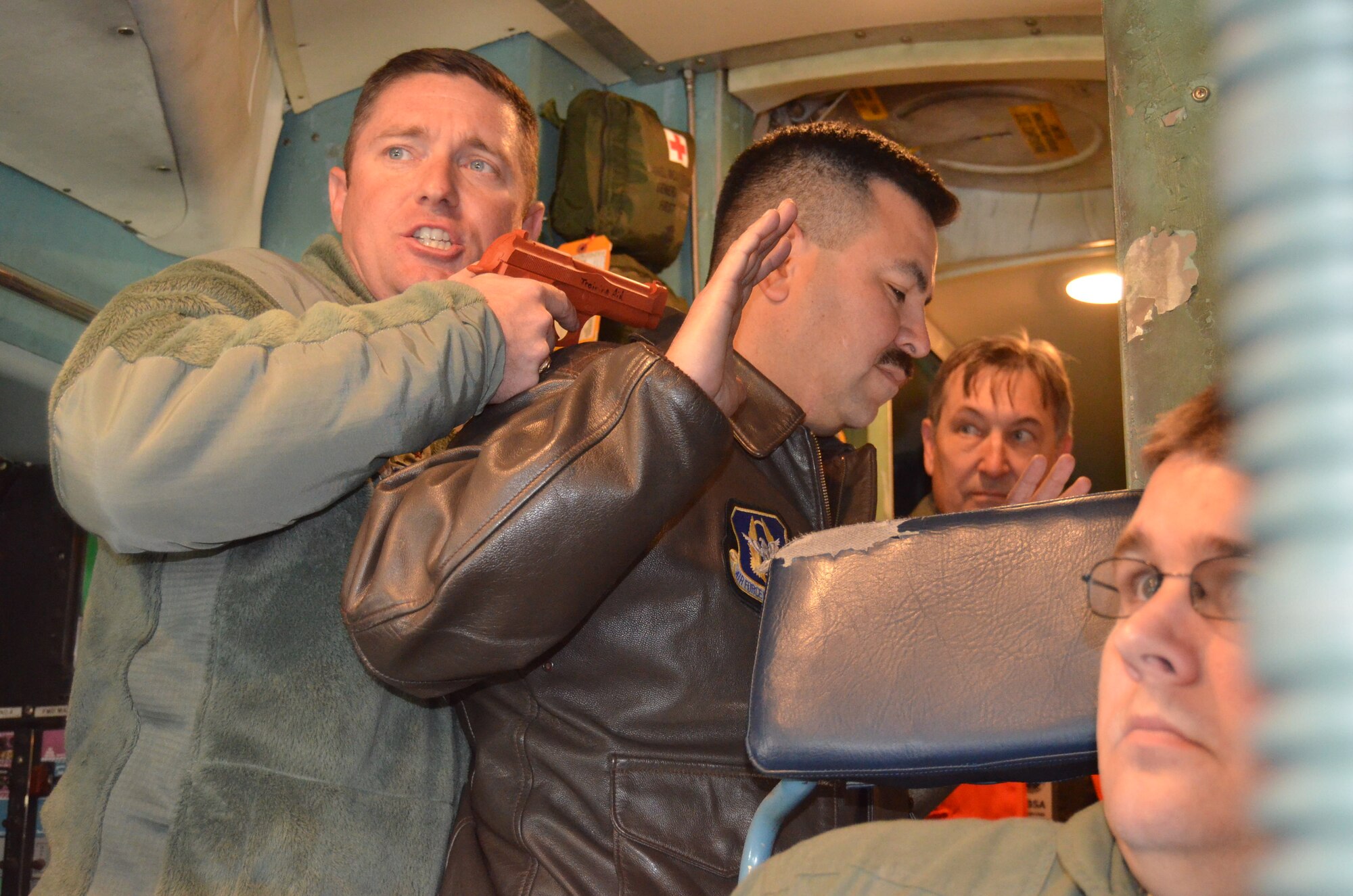 Maj. Wallace Collins, II, 433rd Airlift Wing Performance Manager, makes a demand of negotiators during a Joint Base San Antonio-Lackland anti-hijacking exercise Dec. 5, 2014. The exercise tested the command and control capabilities of JBSA leadership as well as other civilian, federal and other Department of Defense entities.  (U.S. Air Force Photo/ Maj. Tim Wade)