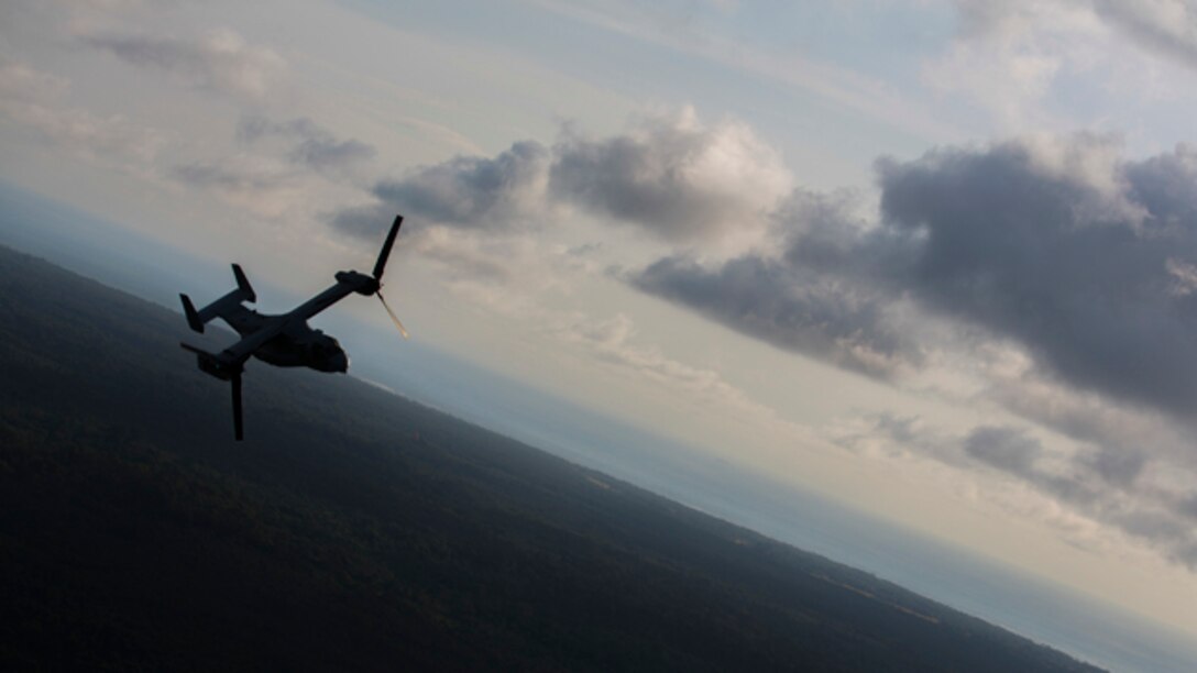 A U.S. Marine Corps MV-22B Osprey with SPMAGTF Crisis Response - Africa returns to base after dropping off supplies that will be used by local and international health organizations to build Ebola Treatment Units while in support of Operation United Assistance in Liberia, Nov. 21, 2014. United Assistance is a Department of Defense operation to provide command and control, logistics, training, and engineering support to U.S. Agency for International Development- led efforts to contain the Ebola virus outbreak in West African nations. (U.S. Marine Corps photo by Lance Cpl. Andre Dakis/SPMAGTF-CR-AF Combat Camera/Released)