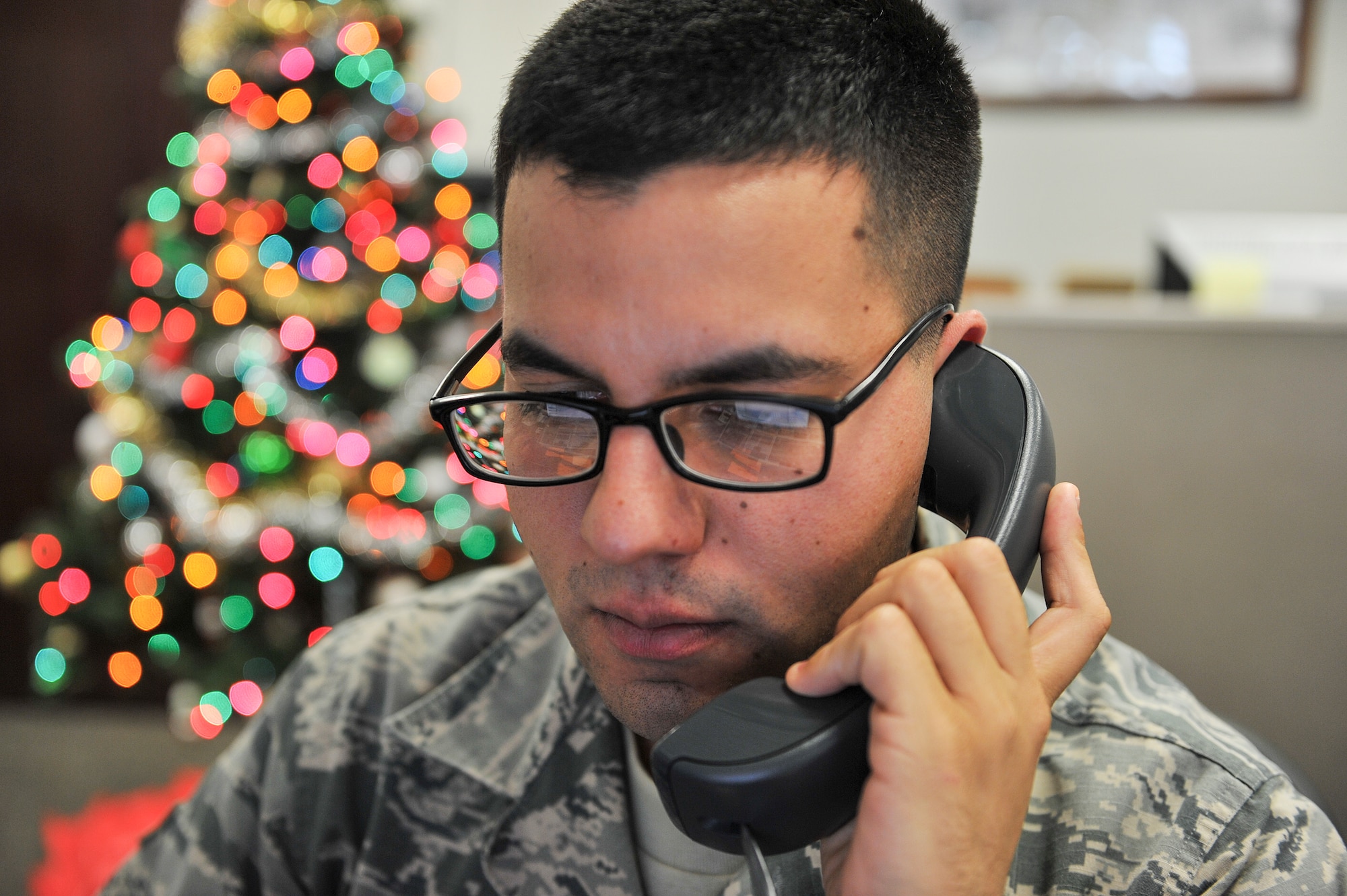 Airman 1st Class Joseph Olachea, 1st Special Operations Civil Engineer Squadron civil engineer journeyman takes a work order request at the “Fish Bowl” on Hurlburt Field, Fl., Dec. 4, 2014. The work orders are then sent to the appropriate offices within the 1 SOCES for completion. (U.S. Air Force photo/Airman 1st Class Jeff Parkinson)