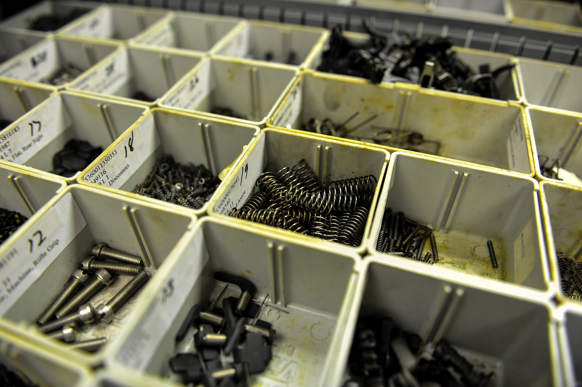Sort M4 rifle replacement parts sit on a table at the firing range on Hurlburt Field, Fla., December 2, 2014. CATM instructors provide firing training and maintain all weapons used by CATM and Security Forces. (U.S. Air Force photo/Airman 1st Class Jeff Parkinson)