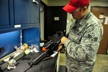 Senior Airman Christopher Crawley, 1st Special Operations Security Forces Squadron Combat Arms Training and Maintenance instructor, function tests an M4 rifle after repairing it at Hurlburt Field, Fla., December 2, 2014. CATM instructors provide firing training and maintain all weapons used by CATM and Security Forces. (U.S. Air Force photo/Airman 1st Class Jeff Parkinson)