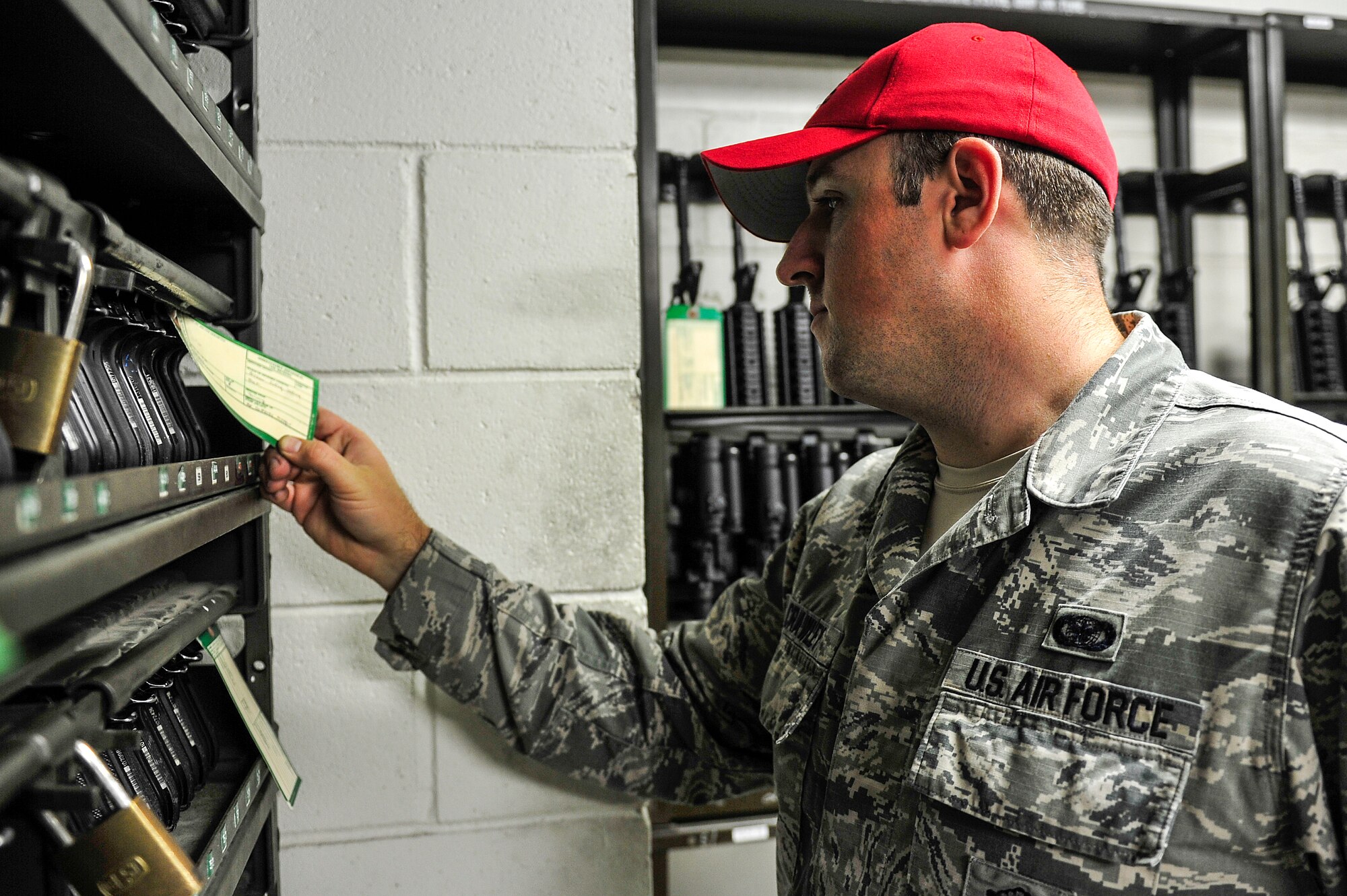 Senior Airman Christopher Crawley, 1st Special Operations Security Forces Squadron Combat Arms Training and Maintenance instructor, checks am M9 pistol maintenance tag at Hurlburt Field, Fla., December 2, 2014. CATM instructors provide firing training and maintain all weapons used by CATM and Security Forces. (U.S. Air Force photo/Airman 1st Class Jeff Parkinson)
