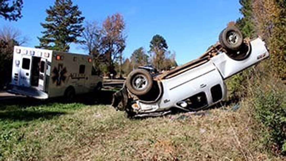 Marines with Bravo Company, 1st Battalion, 23rd Marine Regiment, 4th Marine Division, were the first on the scene of this overturned truck Nov. 26, 2014, after conducting a funeral detail. The woman inside, Patti Cranford, of Garrison, Texas, was on her way to the funeral when she lost control of her vehicle a mile away from the cemetery.