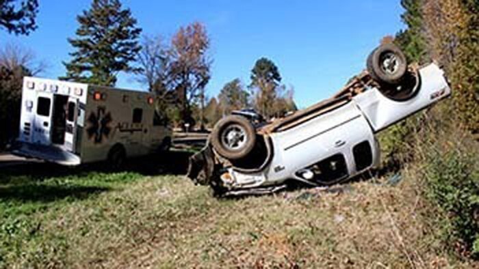 Marines with Bravo Company, 1st Battalion, 23rd Marine Regiment, 4th Marine Division, were the first on the scene of this overturned truck Nov. 26, 2014, after conducting a funeral detail. The woman inside, Patti Cranford, of Garrison, Texas, was on her way to the funeral when she lost control of her vehicle a mile away from the cemetery.
