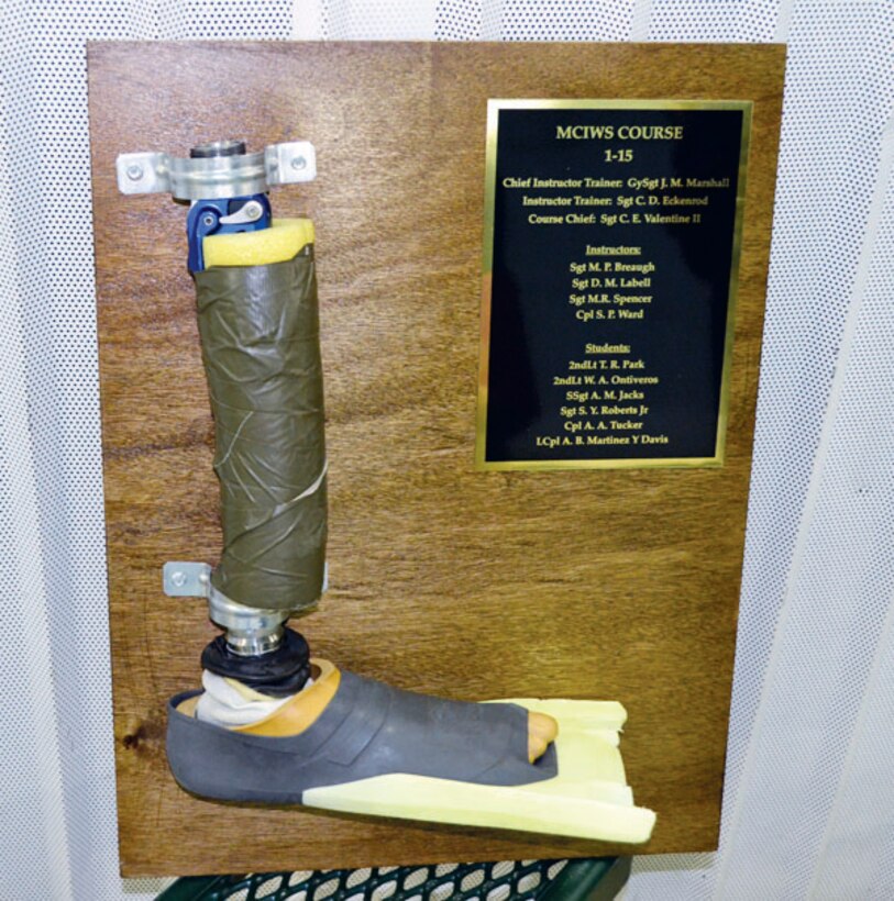 As a lasting gift to the staff of Ramer Hall, the recent graduates of the Marine Combat Instructor of Water Survival course created a plaque that held the improvised prosthetic limb of Staff Sgt. Adam Jacks, the first single-limb amputee to complete the training. 