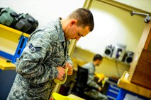 Senior Airman Jeff Wengel, a 1st Special Operations Squadron aircrew flight equipment journeyman, inspects a new life preserver unit at Hurlburt Field, Fla., Dec. 4, 2014. AFE journeymen are in charge of ensuring all flight equipment is in perfect working order. (U.S. Air Force photo/Senior Airman Christopher Callaway) 
