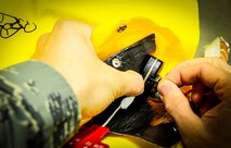 Senior Airman Glen Lalone, a 1st Special Operations Support Squadron flight equipment journeyman, threads string into a life preserver unit at Hurlburt Field, Fla., Dec. 4, 2014. Lalone works at the 8th Special Operations Squadron Air Crew Flight Equipment office. (U.S. Air Force photo/Senior Airman Christopher Callaway) 