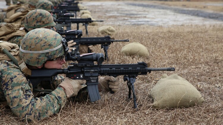 Lance Cpl. Anthony A. Ayr, rifleman with 2nd Platoon, Company A, Ground Combat Element Integrated Task Force, confirms his 100-meter zero with the M27 Infantry Automatic Rifle during a three-day field exercise at the Verona Loop training area on Marine Corps Base Camp Lejeune, North Carolina, Dec. 3, 2014.
