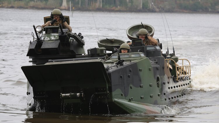 Marines with the Amphibious Assault Vehicle Platoon, Company B, Ground Combat Element Integrated Task Force, come ashore at the French Creek loading dock at Marine Corps Base Camp Lejeune, North Carolina, Dec. 2, 2014, to transport Company A Marines to the Verona Loop training area on Camp Lejeune to conduct a three-day live-fire training event with the M27 Infantry Automatic Rifle. 