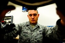 Senior Airman Jeff Wengel, a 1st Special Operations Squadron aircrew flight equipment journeyman, inspects a CV-22 Helmet at Hurlburt Field, Fla., Dec. 4, 2014. AFE journeymen instruct aircrews on the purpose, operations, care and use of aircrew equipment. (U.S. Air Force photo/Senior Airman Christopher Callaway) 